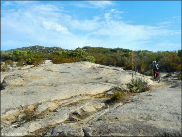 Photo of rider going through a section of solid rock.