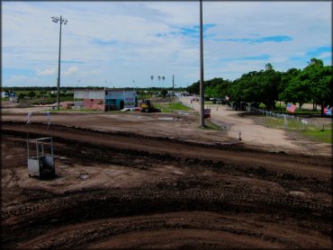 View from motocross track of staging area with backhoe.