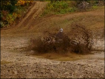 ATV going through mud puddle.