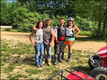 Two men wearing Fox Racing Chest Protectors, Alpinestar boots and O'neal motocross jerseys standing alongside two four wheelers.