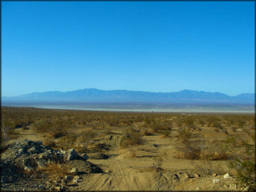 Scenic view of desert trails and lake bed in the far distance.