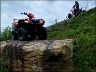 Honda ATV Sitting atop a Large Rock Ledge