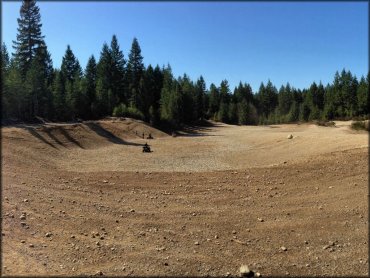 Small group of ATV riders at gravel pit.