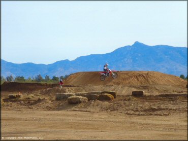 Honda CRF Dirtbike getting air at M.C. Motorsports Park Track