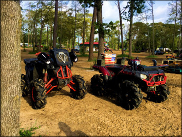 Two custom ATVs parked in the camping area of Xtreme Off-Road Park.