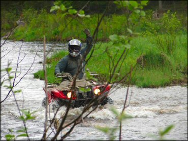 Honda ATV traversing the water at Katahdin Lodge Trail