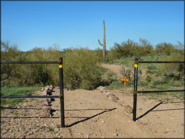 A close up photo of vehicle barrier metal gate at trail entrance.