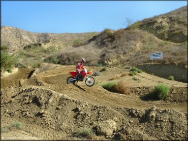 Honda CRF Motorcycle catching some air at MX-126 Track