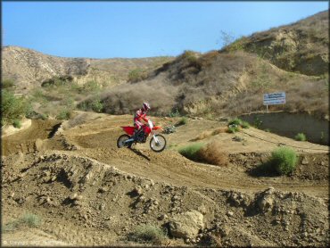 Honda CRF Motorbike catching some air at MX-126 Track