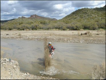 Honda CRF Motorcycle in the water at Black Hills Box Canyon Trail