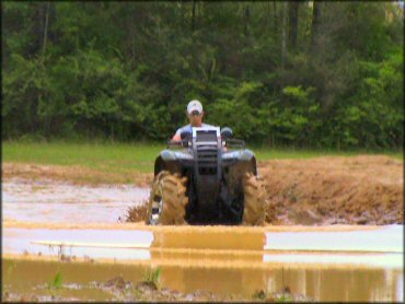 Quad crossing the water at The Bull Pen ATV Park Trail