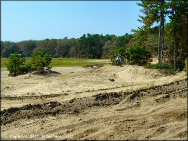 Kawasaki KX Motorcycle getting air at Diamond MX Track