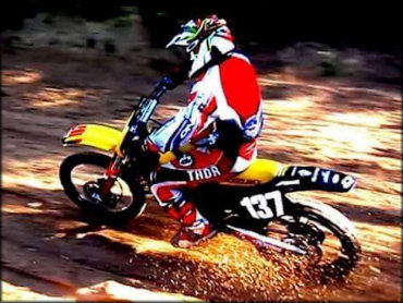 Suzuki RM motocross bike and rider on the track.