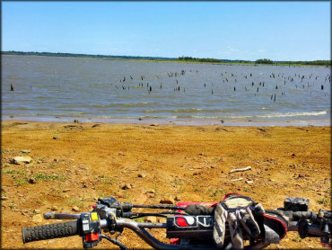 Scenic view of lake taken from seat of dirt bike.