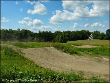 Kawasaki KX Off-Road Bike getting air at Frozen Ocean Motorsports Complex Track