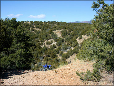 Scenic view of Yamaha Raptor parked on rocky hill.