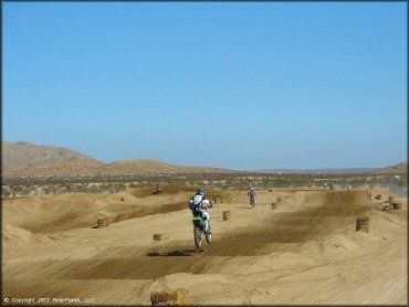 Kawasaki KX Trail Bike getting air at Cal City MX Park OHV Area