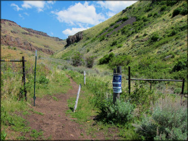 View of cattle gate with signage.