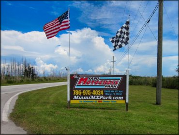 Main entrance sign has American and checkered race flag.