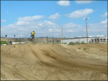 Kawasaki KX Motorcycle jumping at Milestone Ranch MX Park Track