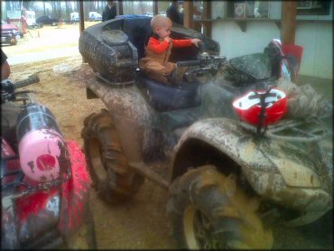 ATV with mud tires and rear cargo.