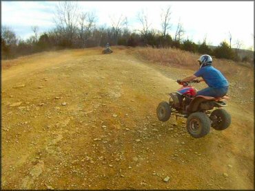 Two men on ATVs.