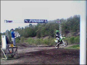 Kawasaki KX Dirt Bike jumping at Walden Motocross Track