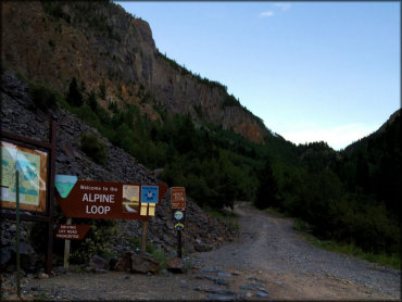 The Alpine Loop trailhead kiosk with a large map, regulations and permit information.