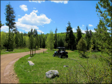 Polaris UTV parked near campsite with picnic table.