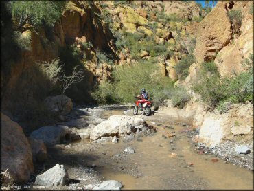 Small stream with gravel and loose chunk rock.