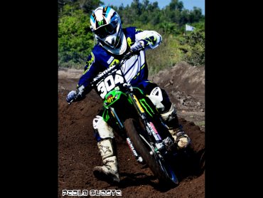 Motocross rider wearing Thor racing gear and Alpinestar boots on Kawasaki dirt bike.