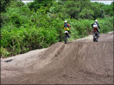 Two motocross bikes on the track.