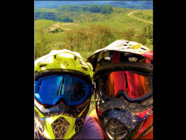 Two children wearing helmets and goggles.