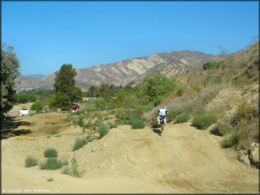 Motorcycle catching some air at MX-126 Track