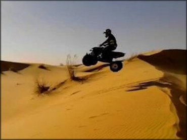 ATV jump from sand dune.