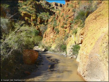 Scenic view of shallow stream going through colorful box canyon.