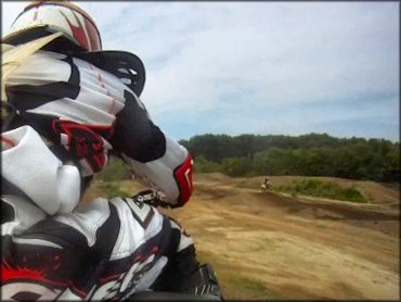 Dirt bike rider with red and white O'Neal motocross gear.