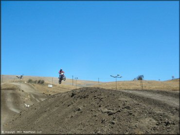 Motorcycle catching some air at Club Moto Track