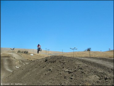 Trail Bike getting air at Club Moto Track