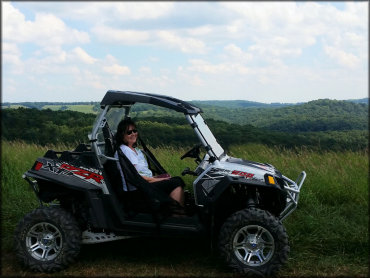 Polaris RZR XP Ranger 900 parked in front of a scenic backdrop.