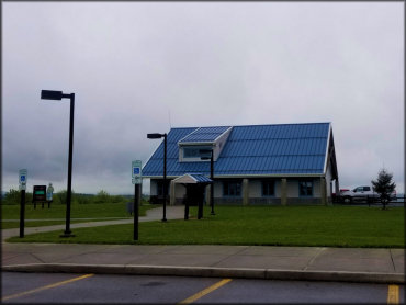 A Facilities Building Building With a Smokey The Bear Fire Danger Sign in Front