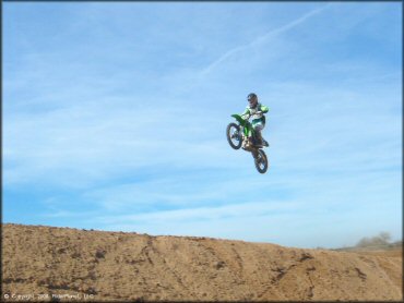 Kawasaki KX Dirt Bike catching some air at Motoland MX Park Track