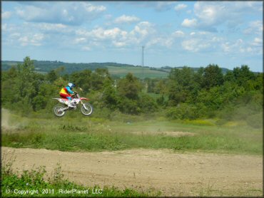 Honda CRF Trail Bike catching some air at Frozen Ocean Motorsports Complex Track