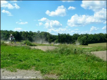 Kawasaki KX Off-Road Bike getting air at Frozen Ocean Motorsports Complex Track