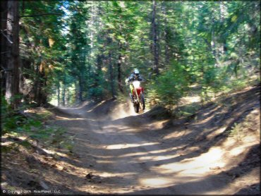 Honda CRF Motorcycle catching some air at Gold Note Trails