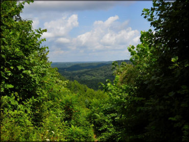 Dense vegetation and rolling hills surround park.