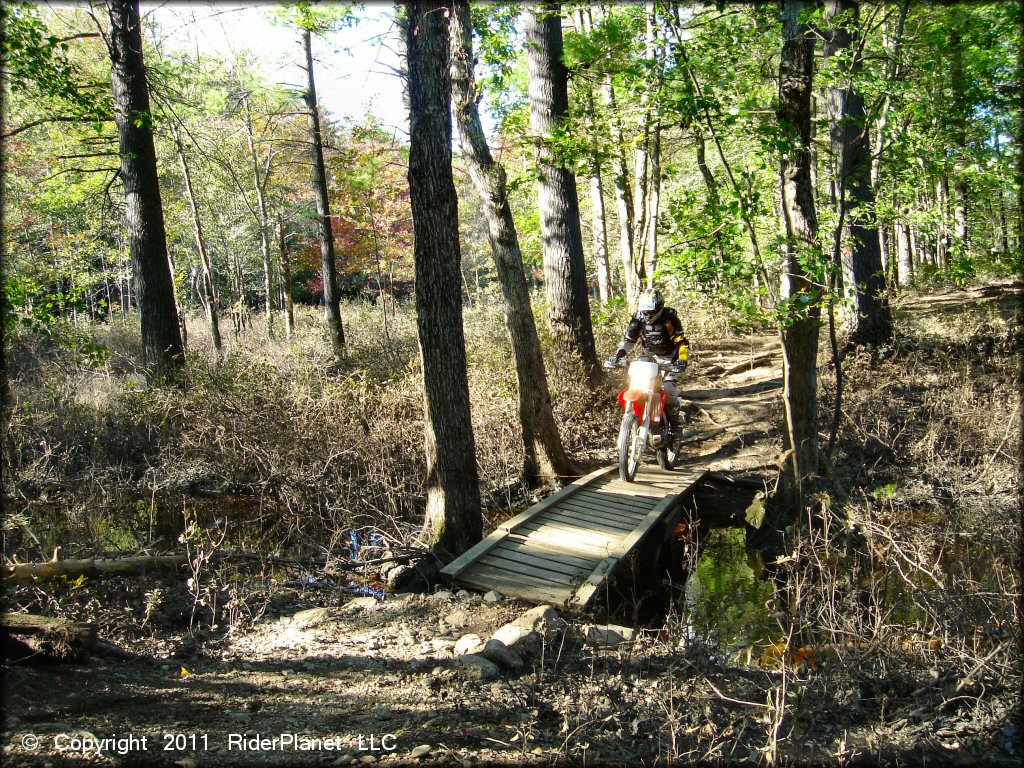 Honda CRF Motorcycle crossing some water at Hodges Village Dam Trail