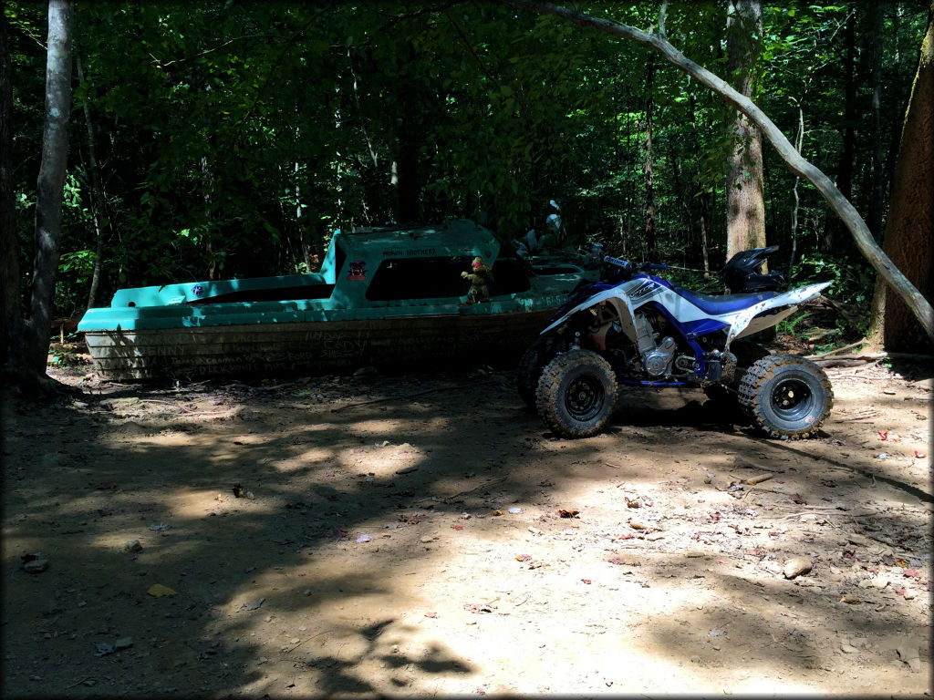 Yamaha Raptor parked next to old boat.