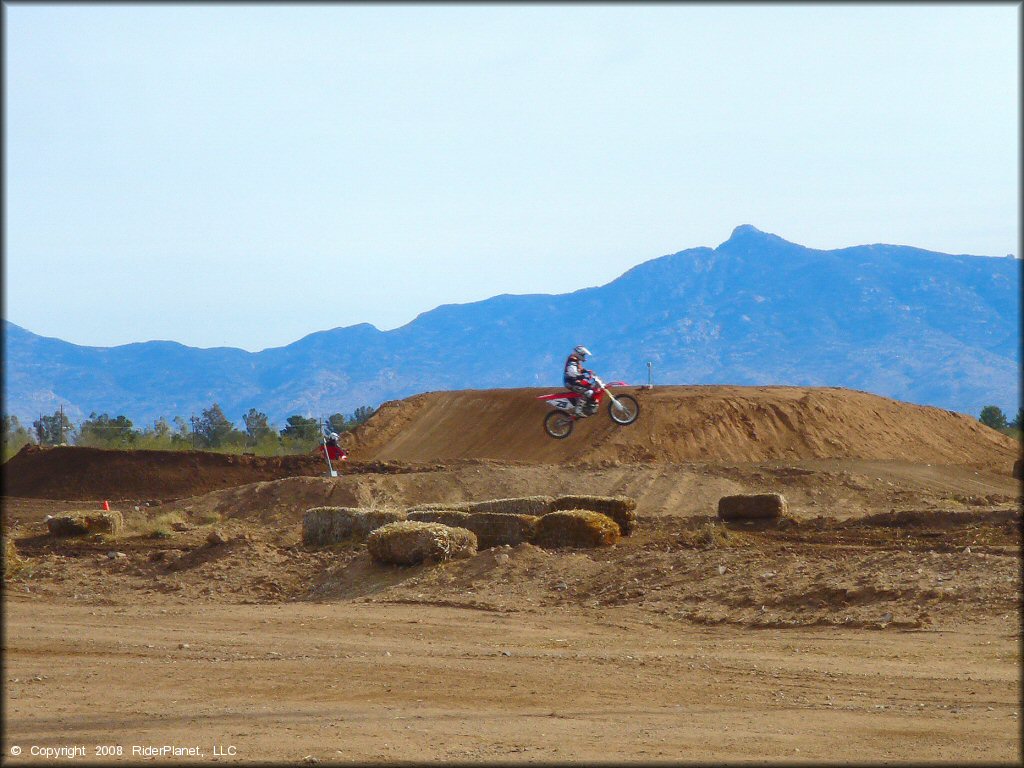 Honda CRF Trail Bike catching some air at M.C. Motorsports Park Track