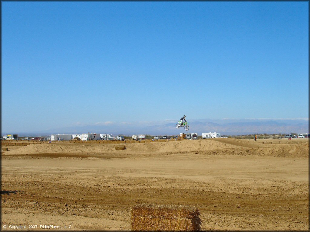 Kawasaki KX Motorcycle jumping at Cal City MX Park OHV Area